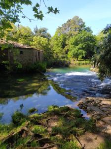 an old building sits next to a river at Vacacional muelle alto A Guarda in A Guarda
