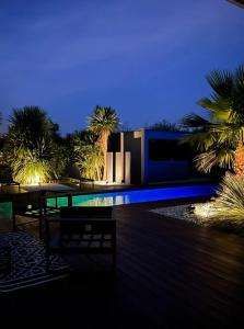 a house with a swimming pool at night at Villa du lac in Arsac