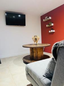 a living room with a table and a couch at Villa du lac in Arsac +21 photos