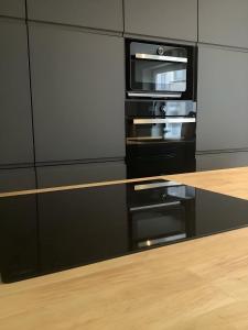 a kitchen with a stove and an oven at Appartement Thout dichtbij zee in Ostend