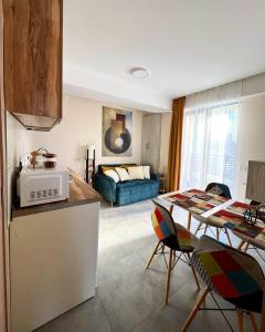 a kitchen and living room with a table and a couch at Didveli, apartment Kesane in Bakuriani