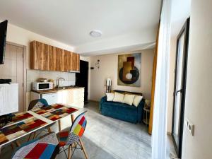 a kitchen and living room with a table and a couch at Didveli, apartment Kesane in Bakuriani +5 photos