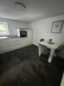 a living room with a white table and a window at Gemütlich Wohnen Sinsheim 2 in Sinsheim