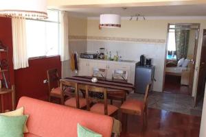 a living room with a table and a kitchen at House Happy Columban in Puno +12 photos
