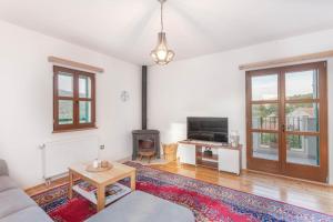 a living room with a couch and a fireplace at Biokovski zagrljaj in Zagvozd