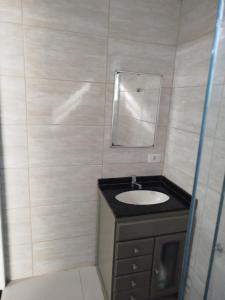 a bathroom with a sink and a mirror at Sítio La Paz in Morretes