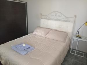 a bedroom with a bed with a towel on it at La Casita de Nala in Neuquén