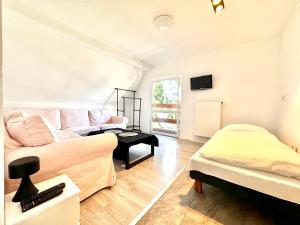 a living room with a couch and a bed at Familly House in Międzyzdroje