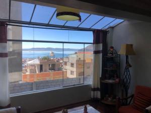 a large window with a view of a city at Apart House Happy CATA 001 in Puno