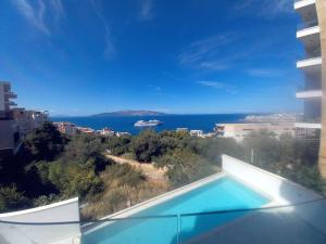 a swimming pool with a view of the ocean at Vanessa Apartment in Sarandë