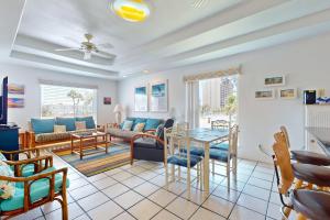 a living room with a table and chairs at Marlin Street Tomehome A in South Padre Island