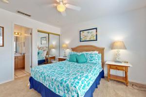 a bedroom with a bed with a blue comforter at Marlin Street Tomehome A in South Padre Island