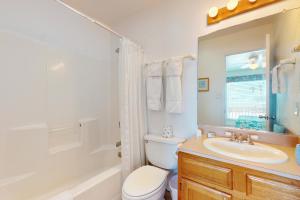a bathroom with a sink and a toilet and a bathtub at Marlin Street Tomehome A in South Padre Island +20 photos