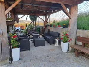 a pergola with chairs and tables and a bench at U Bobaków in Murzasichle