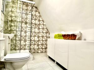 a bathroom with a toilet and a shower curtain at Familly House in Międzyzdroje +19 photos