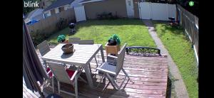 a wooden deck with a table and chairs in a yard at St Paul Fry Street Den Suite#1 in Saint Paul