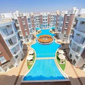 a large swimming pool in the middle of a building at Hotel Room in Aqua Palms Hurghada in Hurghada