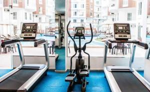 a gym with two treadying machines in front of a window at Hotel Room in Aqua Palms Hurghada in Hurghada