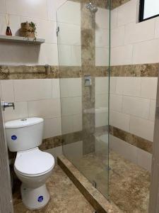 a bathroom with a toilet and a glass shower at Casa Paraiso Ambato in Ambato +9 photos