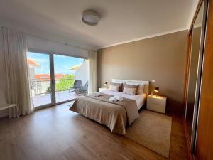 a bedroom with a bed and a large window at Serene View - By SCH in Alvados +89 photos