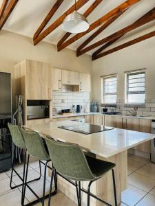 a large kitchen with a table and chairs at The Ridge in Rustenburg +7 photos