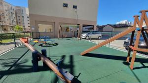 a playground with play equipment on a building at Egidios AP - Centro de São Pedro da Aldeia in São Pedro da Aldeia