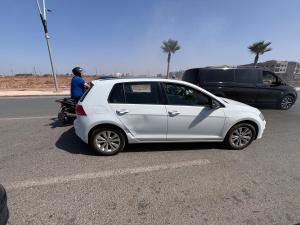 un coche blanco estacionado a un lado de la carretera en Villa avec piscine 2 chambres 2 salon 1 cuisine et piscine privée, en Bouznika