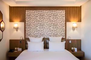 Postel nebo postele na pokoji v ubytování Barceló Palmeraie Oasis Resort