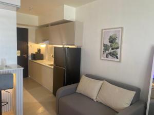 a living room with a couch and a kitchen at B & M Condo near NAIA Airport and SM Mall in Manila