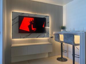 a living room with a tv and two chairs at B & M Condo near NAIA Airport and SM Mall in Manila