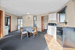 a kitchen and dining room with a table and chairs at City Court in Invercargill