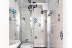a bathroom with a shower and a toilet and a sink at ALFANI DUOMO Suite in Florence