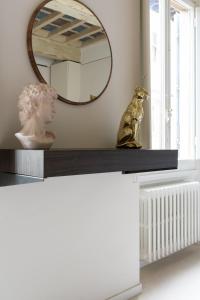 a statue sitting on a shelf with a mirror at ALFANI DUOMO Suite in Florence