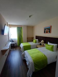 Postel nebo postele na pokoji v ubytování Hotel Puerto Limón CR + 27 fotografií