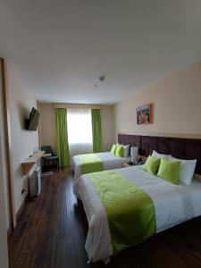 Postel nebo postele na pokoji v ubytování Hotel Puerto Limón CR