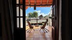 an open door to a patio with a table and chairs at Departamentos en SF - Adults Only in Playa del Carmen