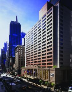 a large building in a city with a street at Executive Class at MTS Hotel in New York