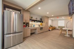 a kitchen with a stainless steel refrigerator and a table at The Jackson SouthTown in Jackson