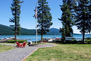 a flag pole in a park next to a lake at Shelter Cove Resort & Marina in Odell Lake