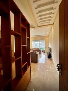a room with a living room with a couch and a door at Appartement de vacances CASABAY Sidi Rehal in Sidi Rahal