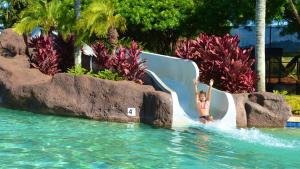 a little girl on a water slide at a resort at Kiahuna Plantation 323 in Kipu