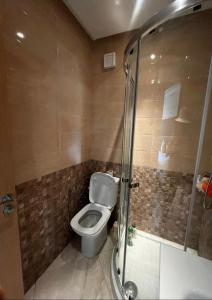 a bathroom with a toilet and a shower at Appartement de vacances CASABAY Sidi Rehal in Sidi Rahal +13 photos
