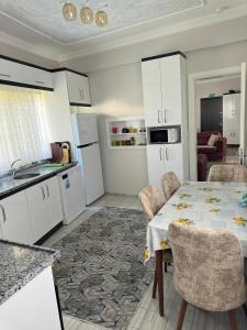 a kitchen and dining room with a table and chairs at Gökçen Home in Pamukkale +22 photos