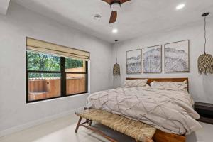 a bedroom with a large bed and a window at Aframe River Retreat, Sauna, Hot Tub, Workspace, New Build! in Beloit