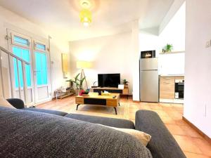 a living room with a couch and a table at Maison Heiwa in Schœlcher