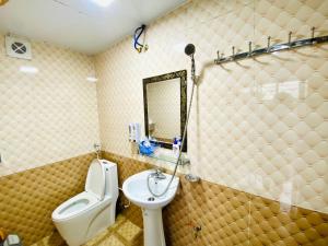 a bathroom with a sink and a toilet and a mirror at Saigonese Villa in Sapa