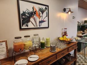 a table with jars of juice and fruit on it at HOTEL BARU in Padre Bernardo