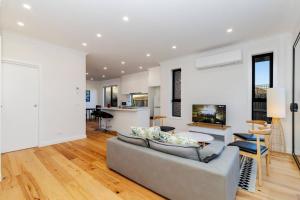 a living room with a couch and a table at 4 Bedrooms Lovely House in Clayton Central in Clayton North