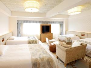 a hotel room with two beds and a television at Tokyo Bay Maihama Hotel First Resort in Urayasu