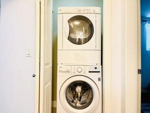 a washer and a washing machine in a room at Langley Heights 2 Bedrooms Sweet Suite in Langley